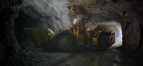 Large wheel loader driving in mining tunnel