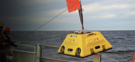 Abalones OBS station with red flag up being brought onto the deck of a ship