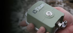 Green Titan Accelerometer held in a persons hand