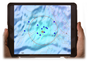 Seismic data displayed on a tablet held in someone's hands