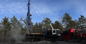 Borehole drilling rig working in forrested area