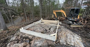 Wood frame being positioned for concrete pad