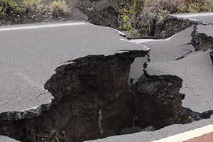 Large hole in a road caused by an earthquake